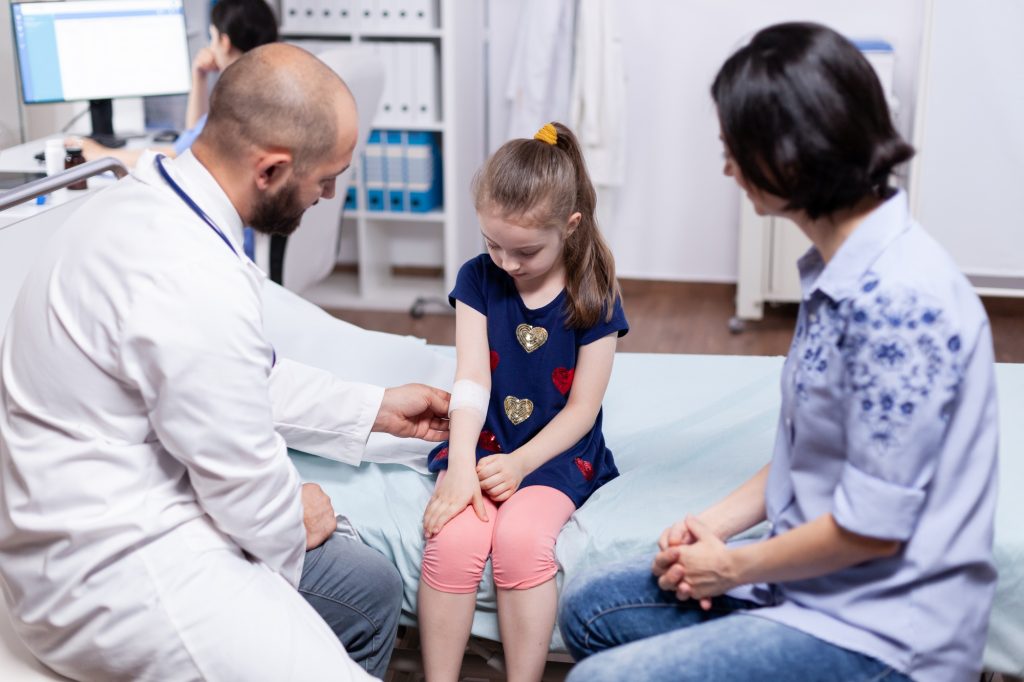 Doctor bandaging child