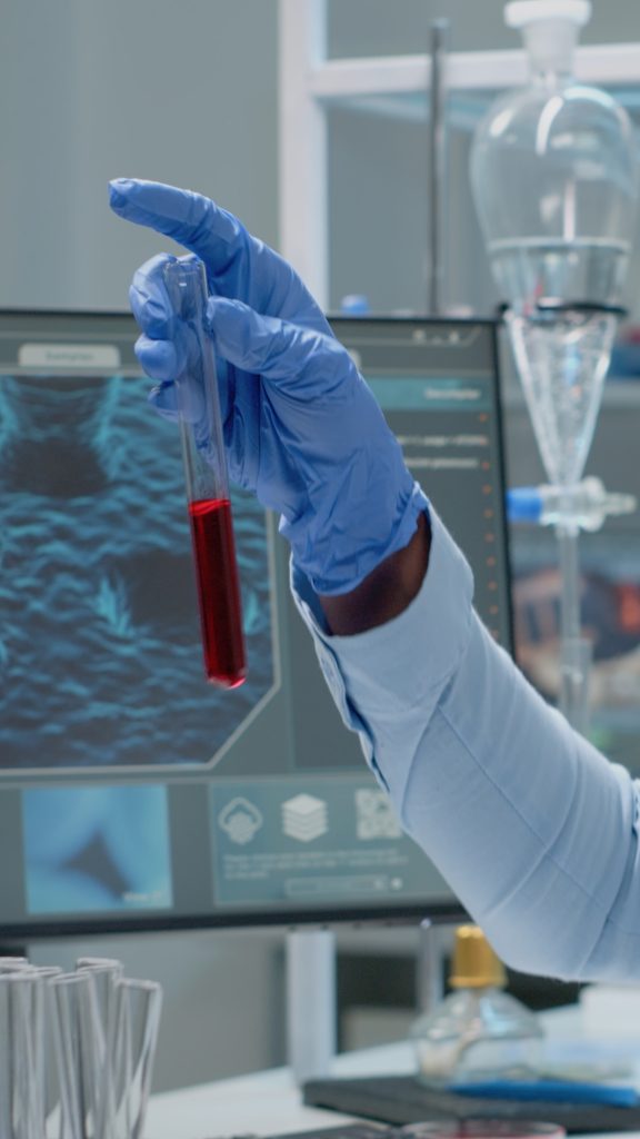 Science specialist studying test tube with blood sample
